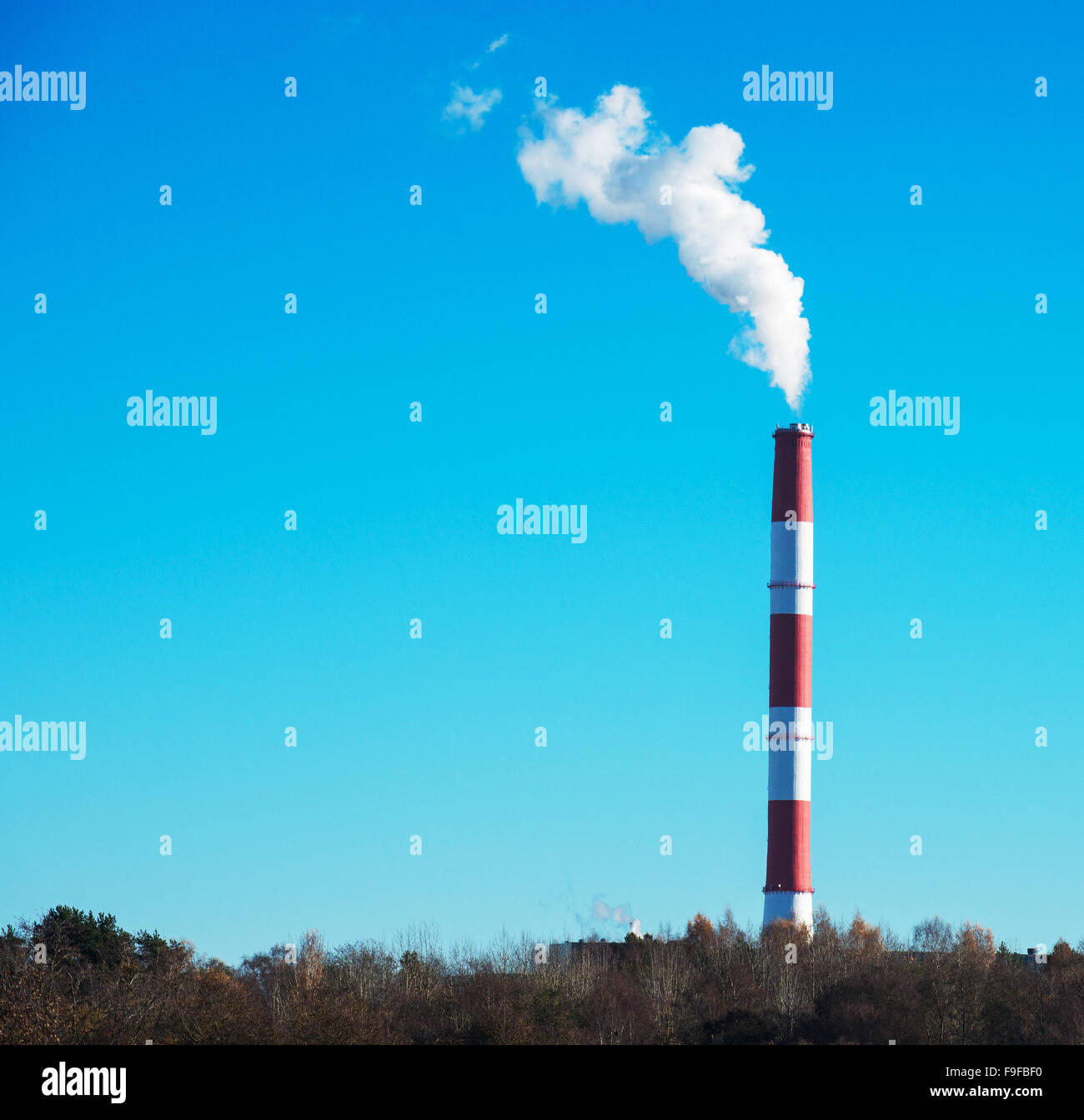 Air pollution. Dirty smog from big factory chimney. Stock Photo