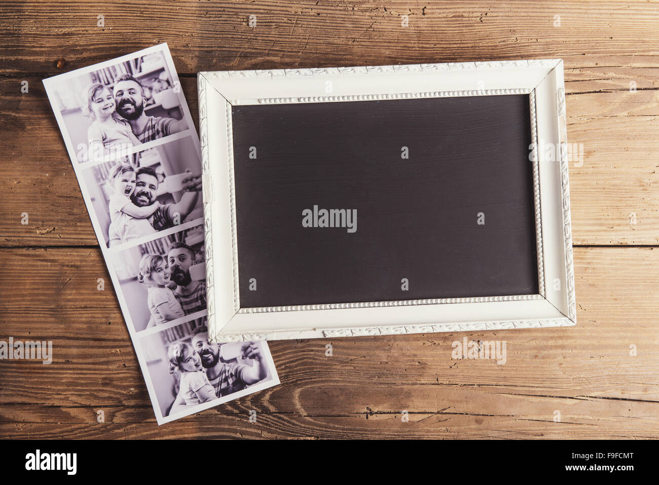 Picture frame and instant photos on wooden background Stock Photo Alamy
