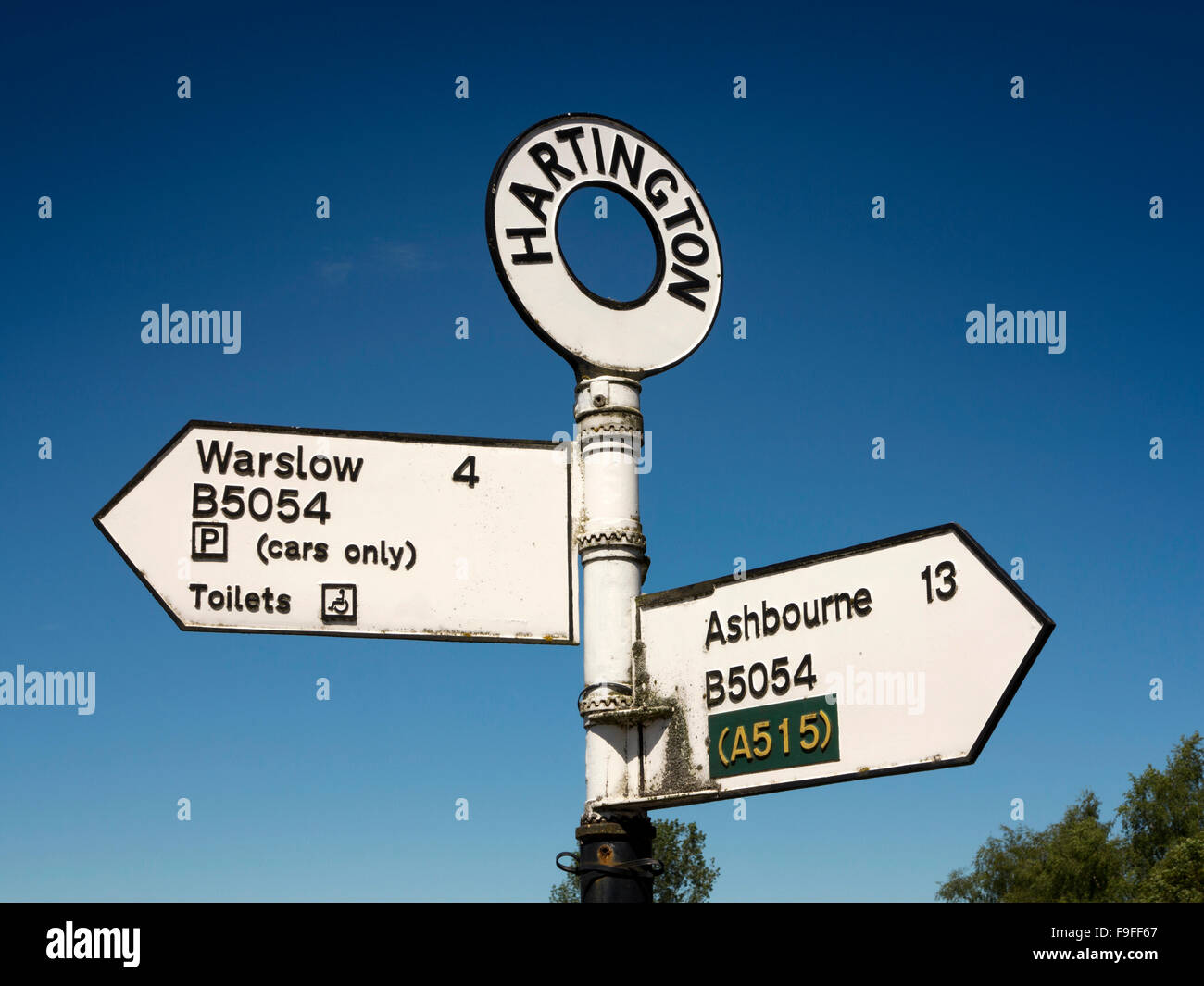 UK, England, Derbyshire, Hartington village road sign post to Ashbourne and Warslow Stock Photo