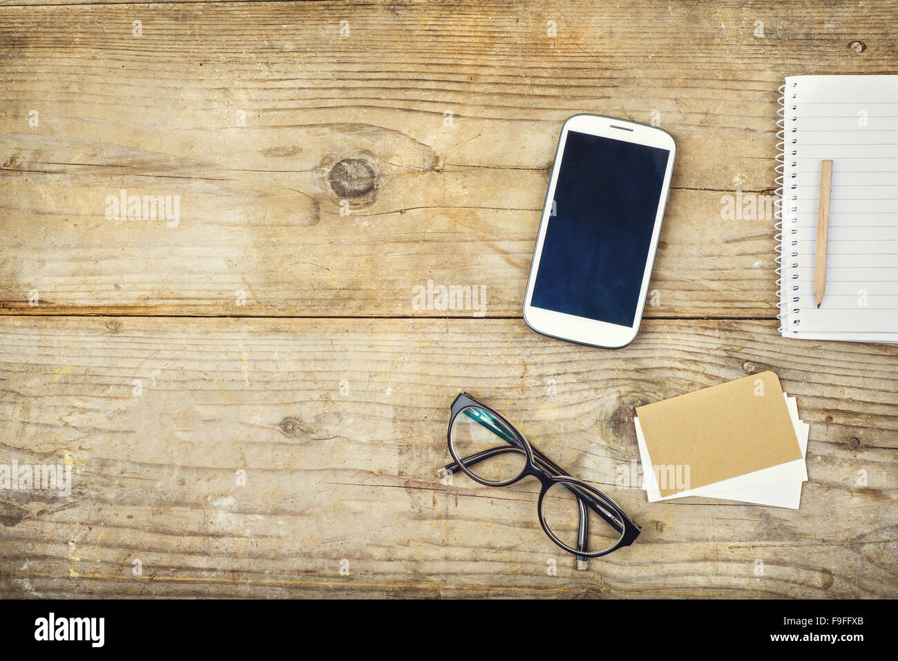 Desktop mix on a wooden office table background. View from above. Stock Photo