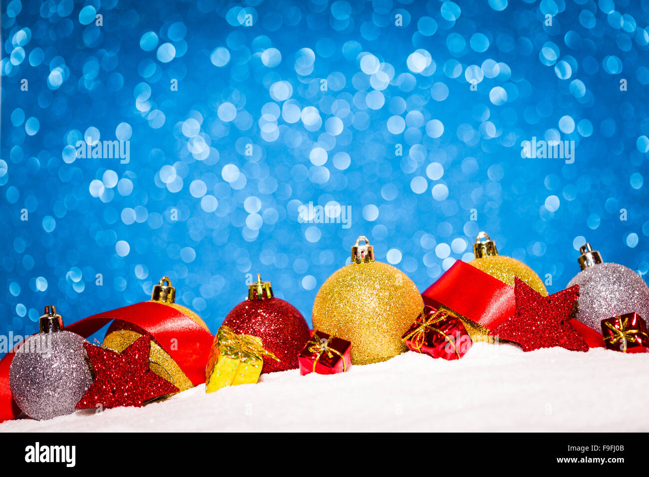 christmas ornament in snow on glitter background Stock Photo - Alamy
