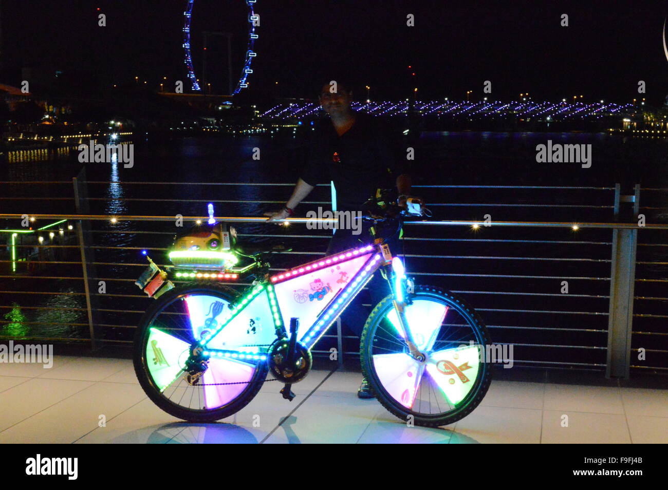 LED illuminating bicycle at Marina bay singapore. The cycle was self  decorated with thousands of led light Stock Photo - Alamy