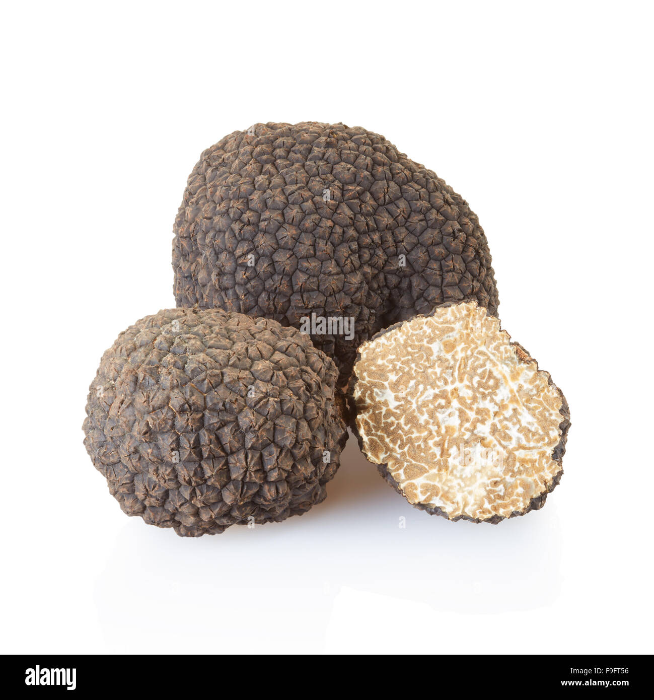 Black truffles and half on white Stock Photo