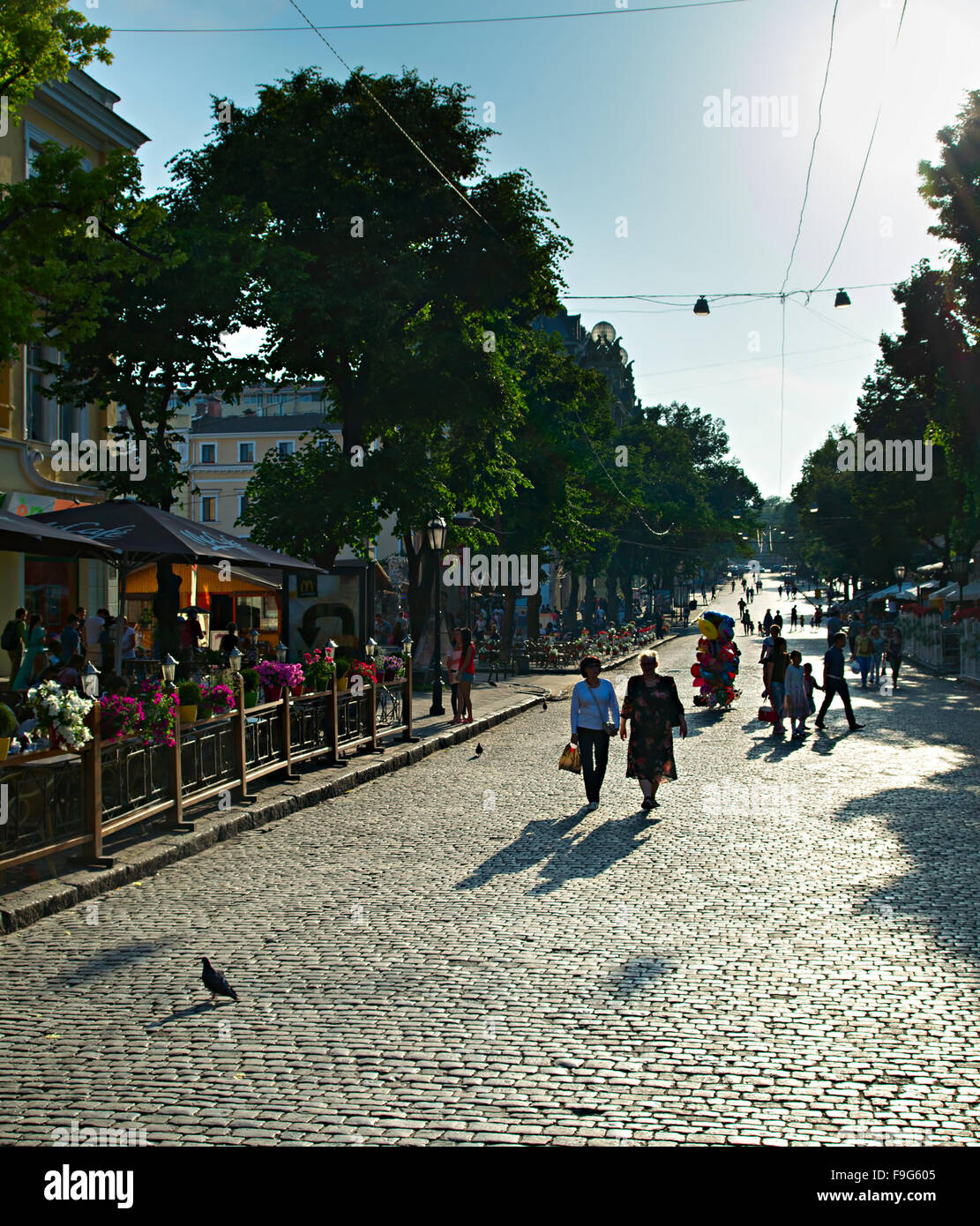 People walking on Deribasovskaya street at sunset. Odessa, Ukraine Stock Photo