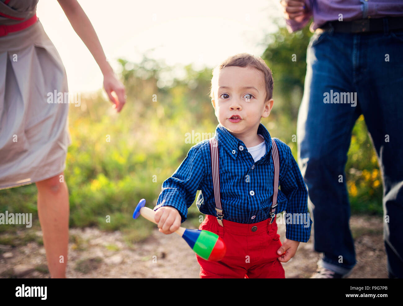 Happy young family having fun outside in summer nature Stock Photo