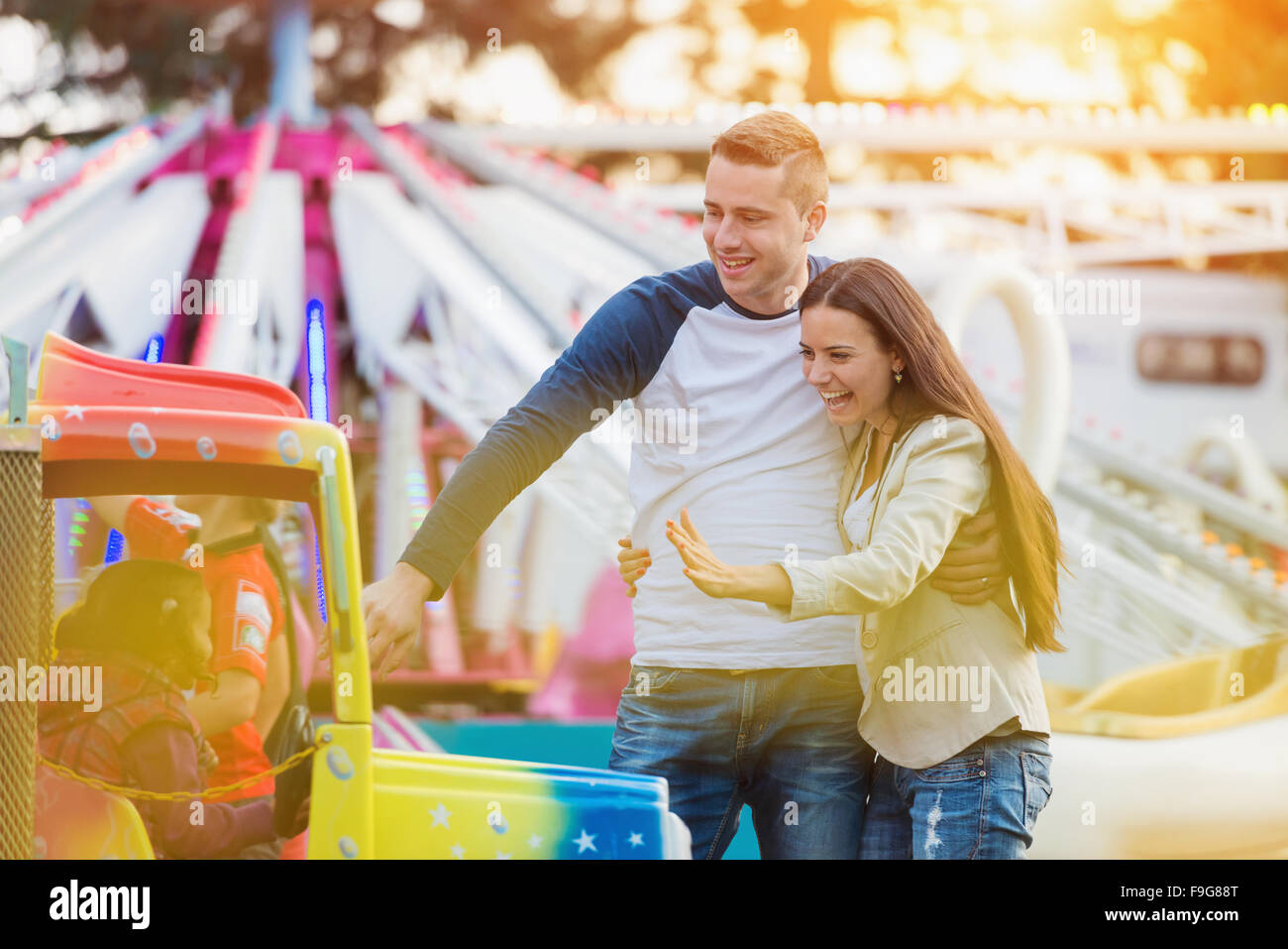Beautiful young family enjoying their time at fun fair Stock Photo