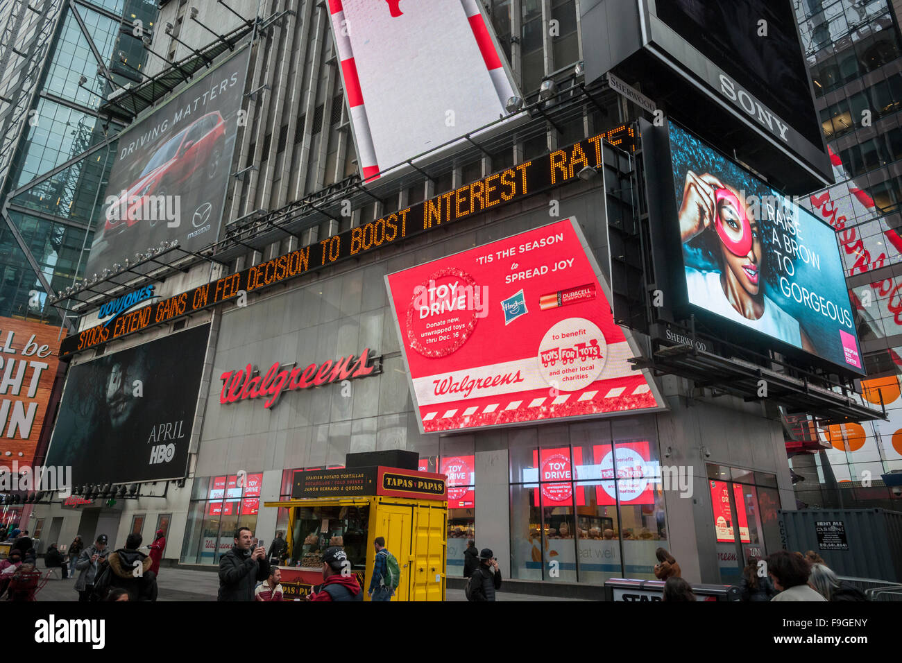 New York, USA. 16th Dec, 2015. The news ticker on One Times Square in New York on Wednesday, December 16, 2015 announces stocks rise after the U.S. Federal Reserve raised interest rates for the first time in 7 years. The rate has been raised 25 basis points with gradual raises each year if deemed necessary. Credit:  Richard Levine/Alamy Live News Stock Photo