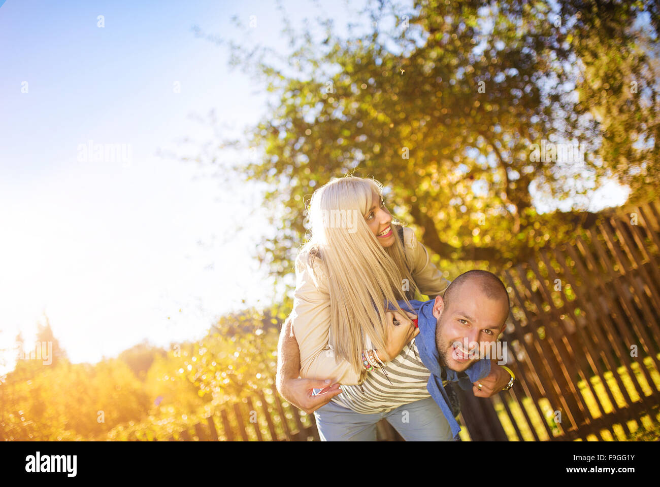 Happy young couple having fun outside in a park Stock Photo