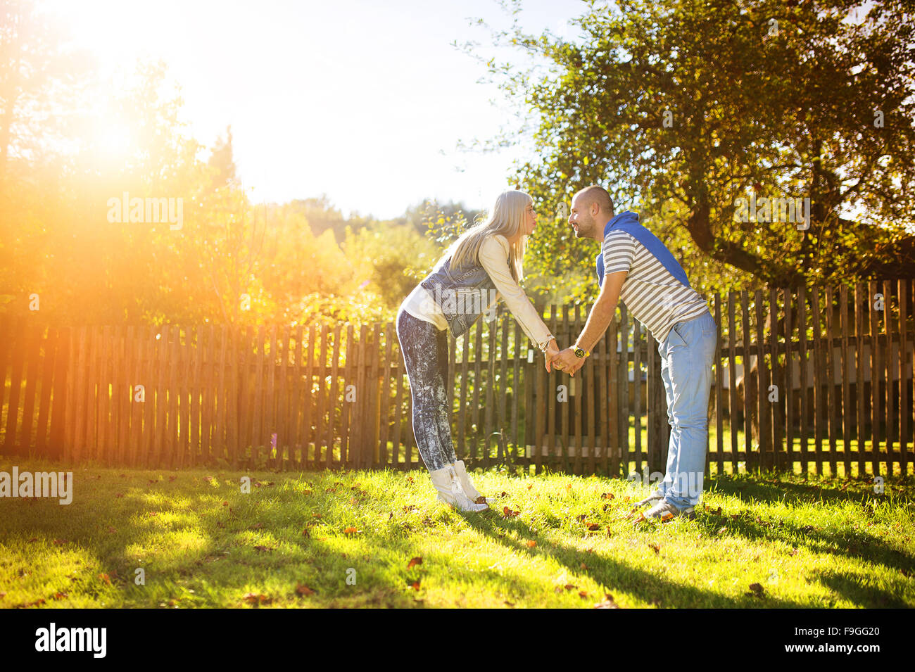Happy young couple having fun outside in a park Stock Photo - Alamy