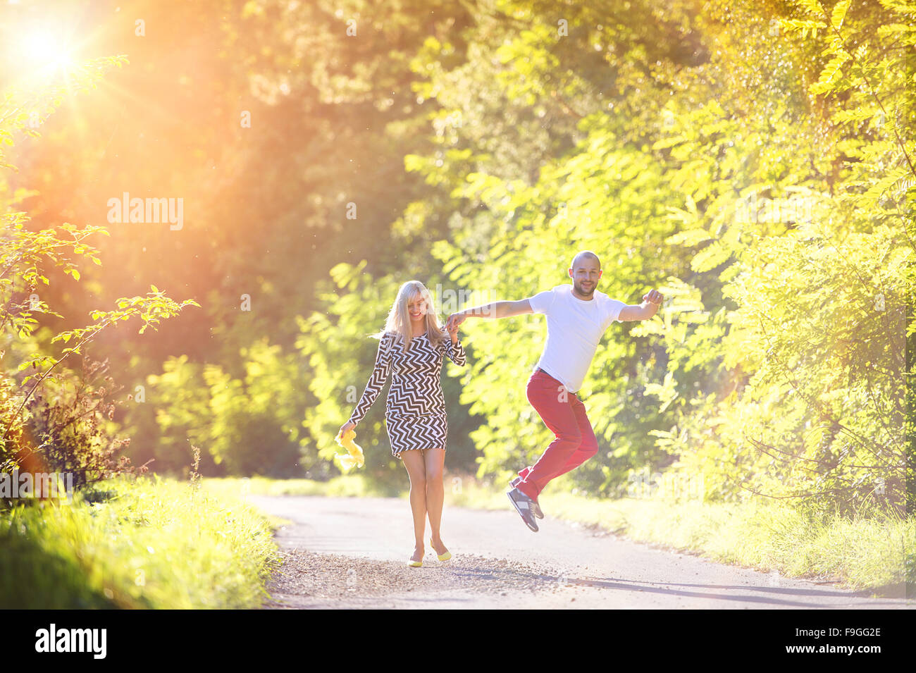 Attractive happy young couple having fun outside in a park Stock Photo ...