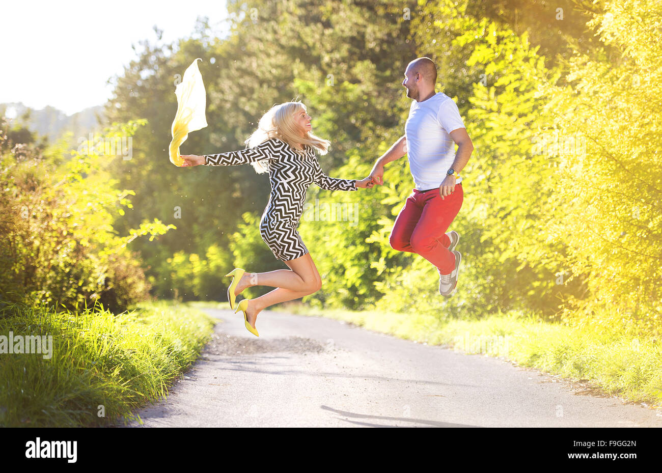 Attractive happy young couple having fun outside in a park Stock Photo ...