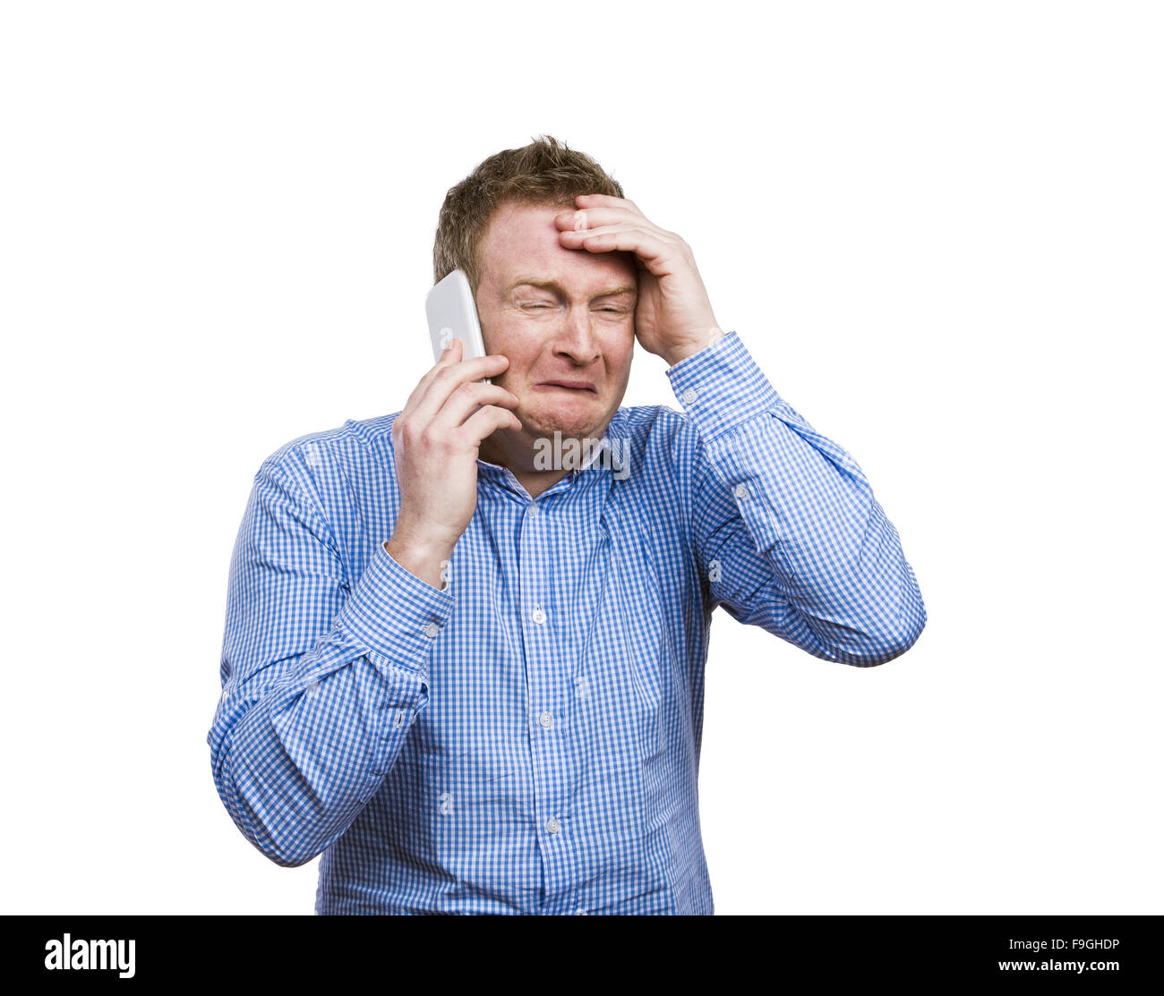 Man making funny faces while making a phone call. Studio shot on white