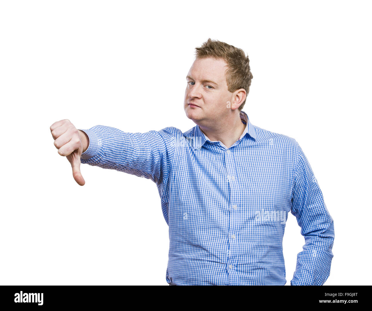 Young man in blue shirt posing. Studio shot on white background. Stock Photo