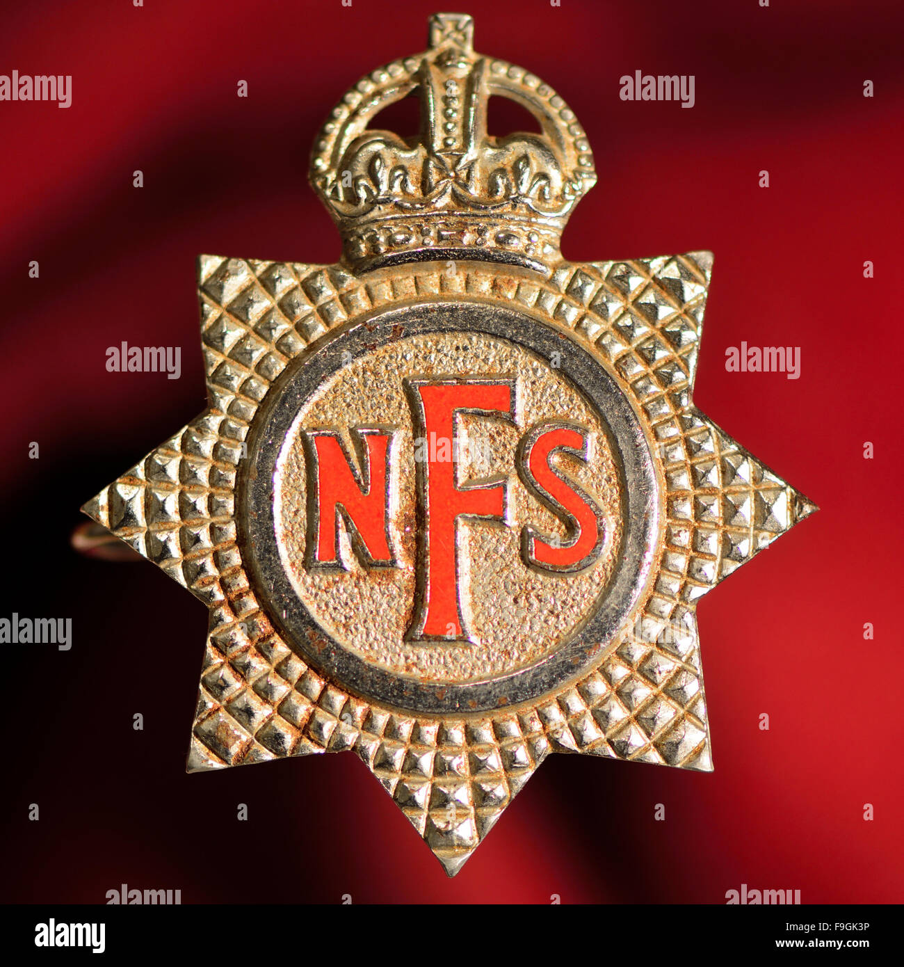 National Fire Service badge. A National Fire Service badge, worn as a cap badge by fire fighters in the UK in WWII Stock Photo