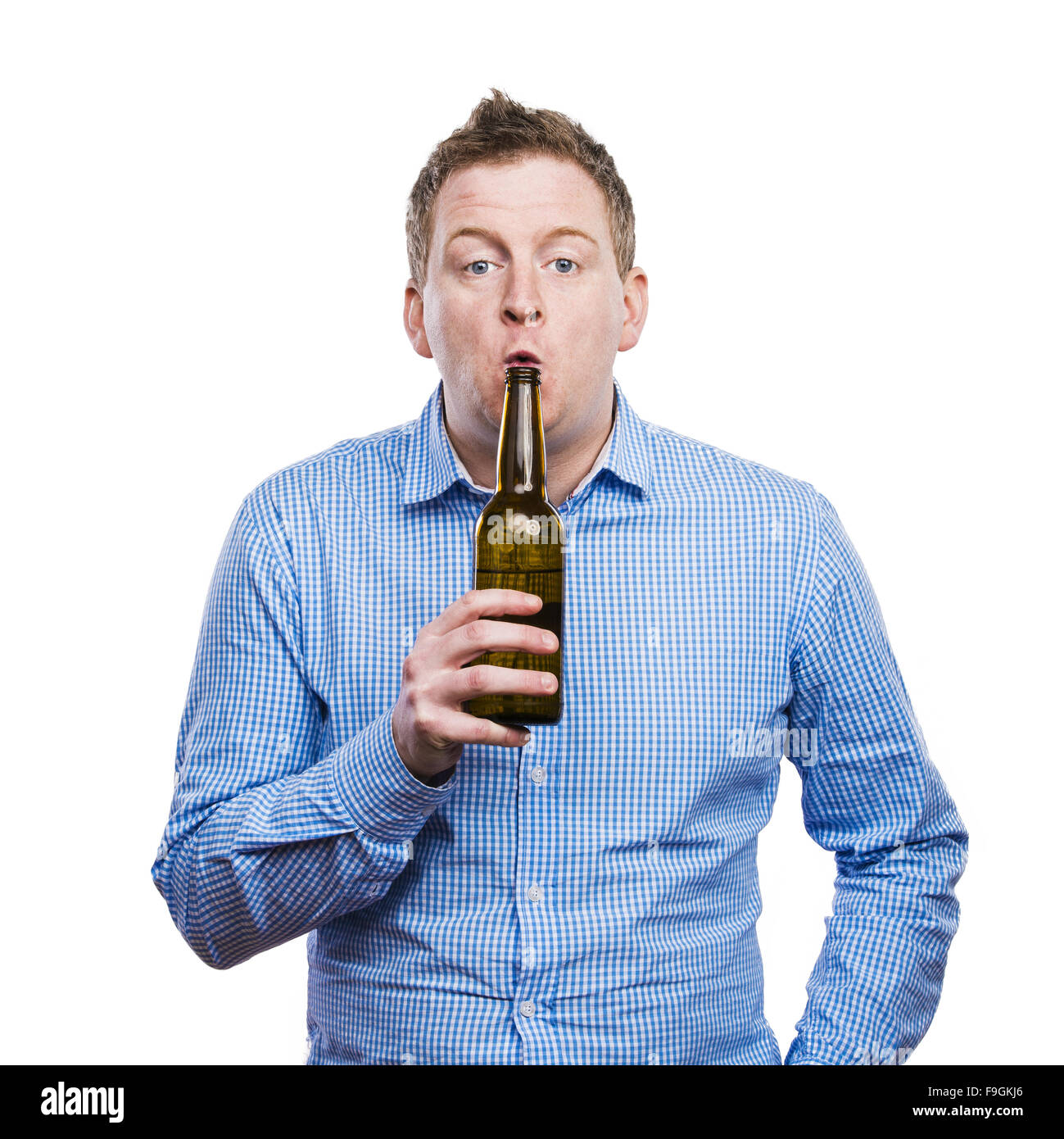 Funny young drunk man holding a beer bottle. Studio shot on white ...