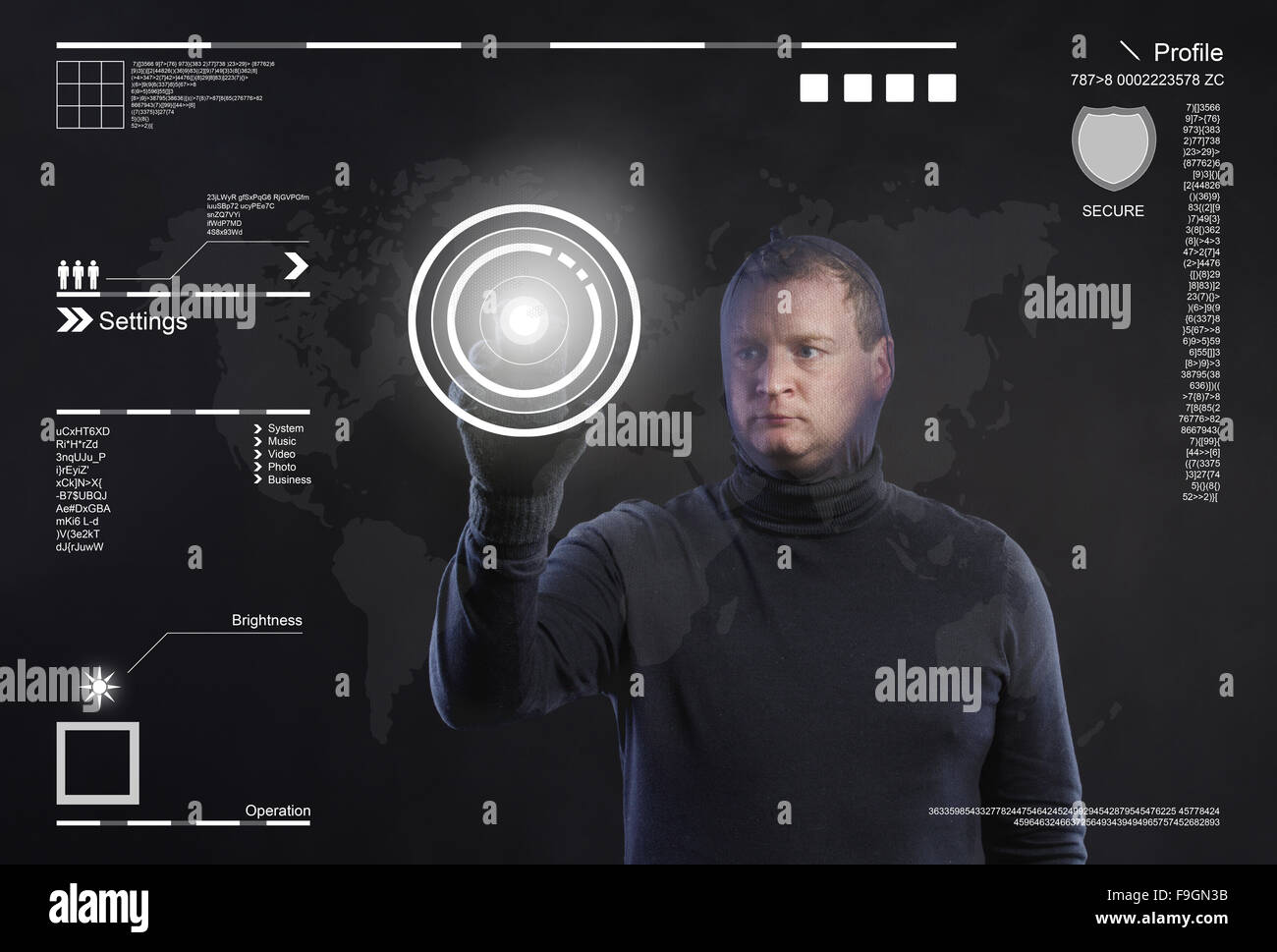 Thief in action stealing information with balaclava on his face, dressed in black. Studio shot on black background. Stock Photo
