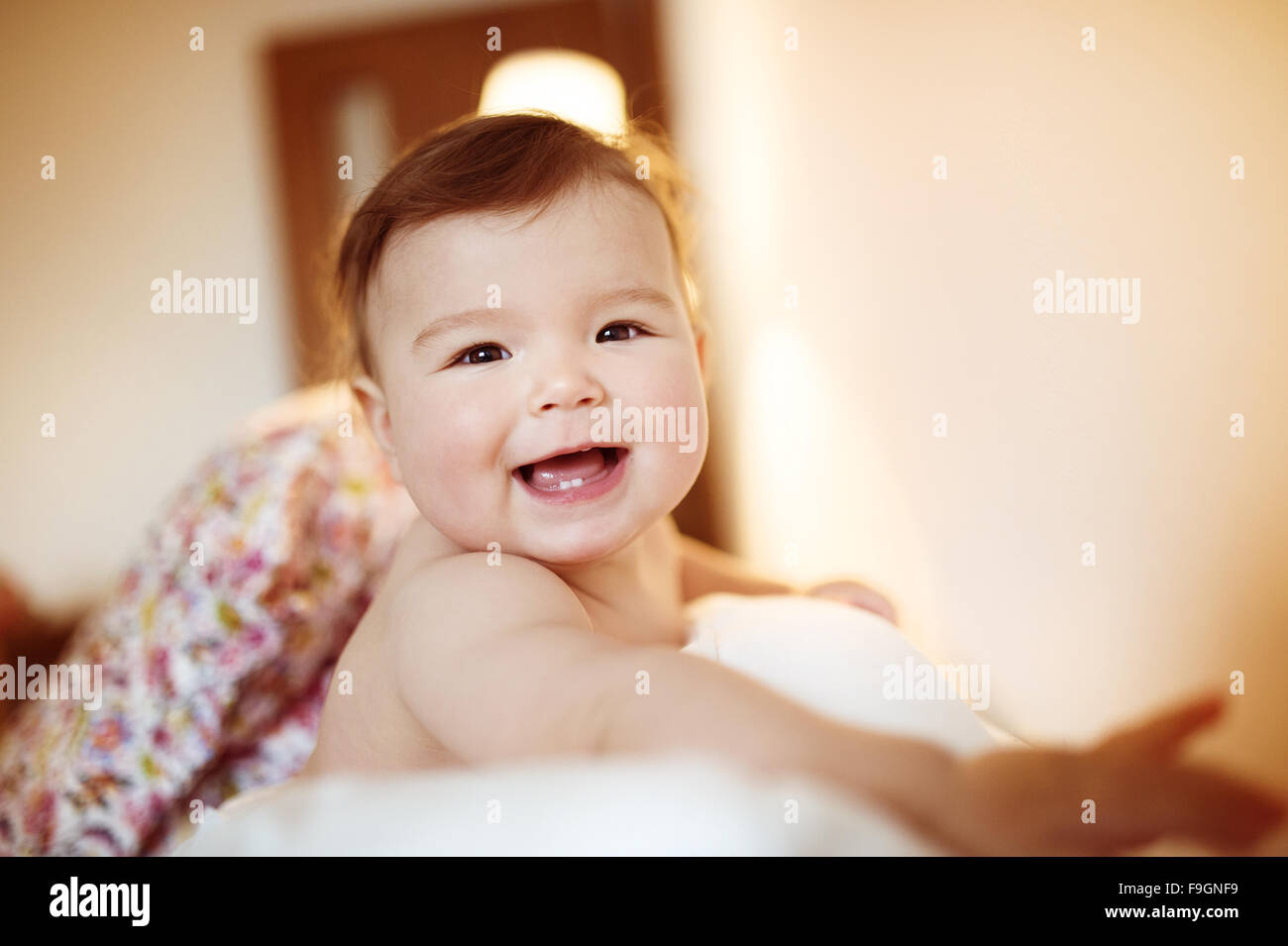 Cute little baby playing and having fun on a sofa Stock Photo