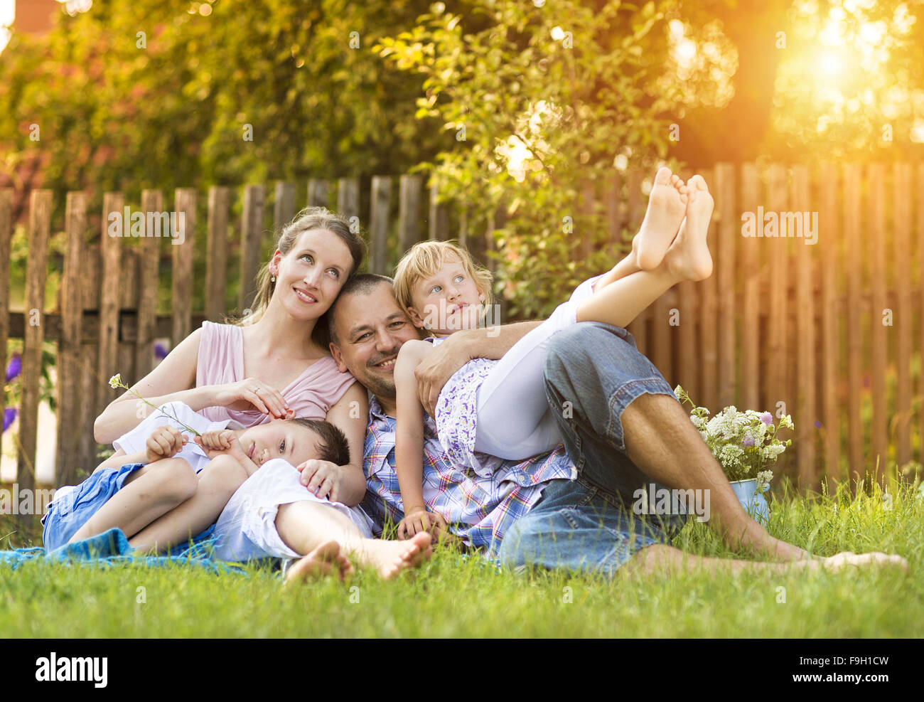 Happy young family spending time together outside in green nature. Stock Photo