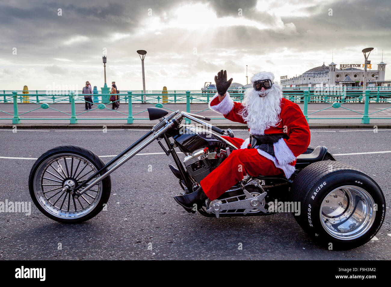 A Man Dressed As Santa Claus Sitting On A Motorcycle Waving, Brighton, Sussex, UK Stock Photo