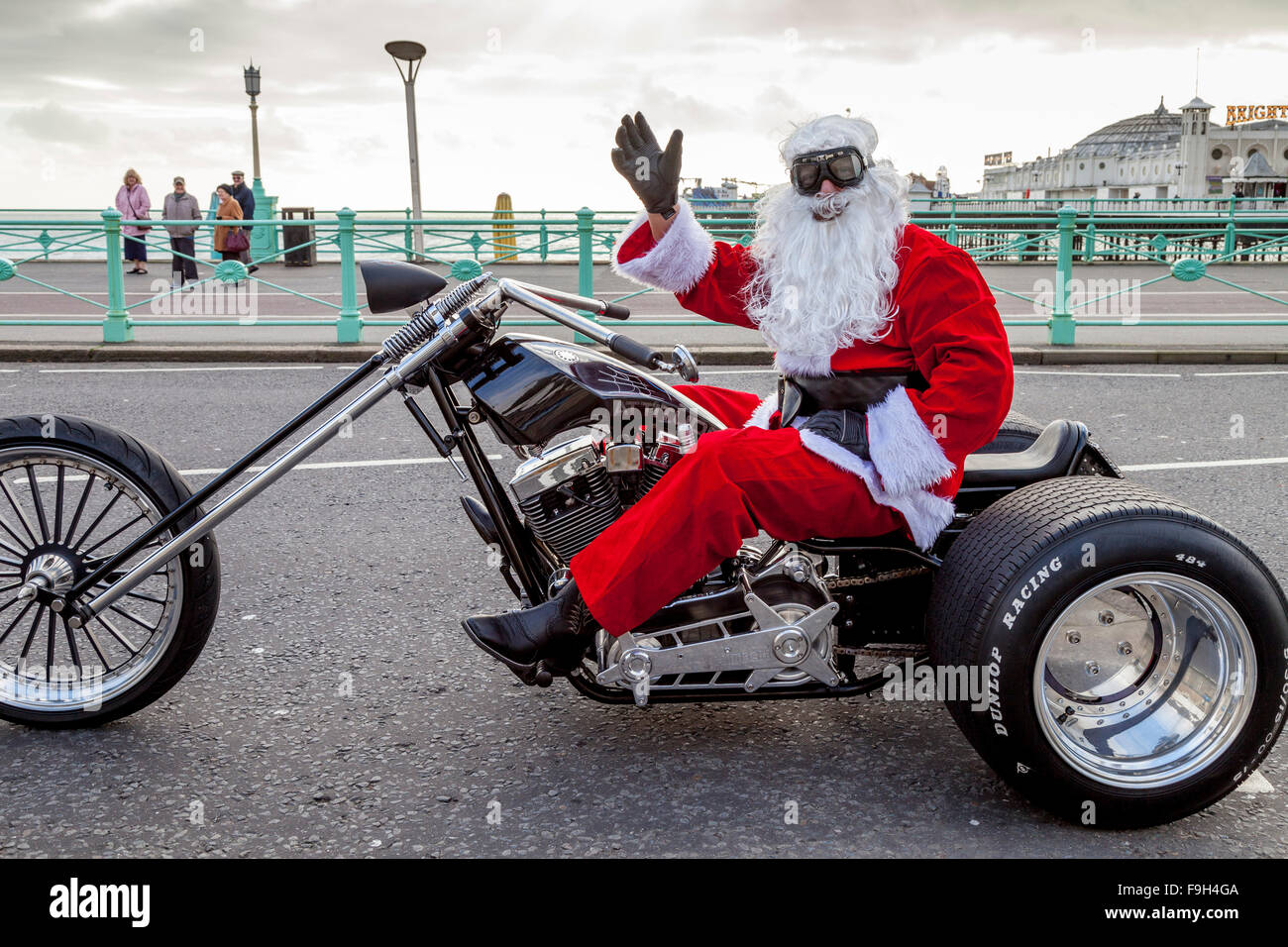 A Man Dressed As Santa Claus Sitting On A Motorcycle Waving, Brighton, Sussex, UK Stock Photo