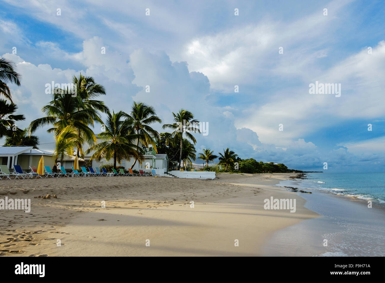 A view of a beachside resort, Cottages By The Sea, at sunrise, St. Croix, U.S. Virgin Islands. Showing the beach and sea. Cottages by the Sea resort. Stock Photo