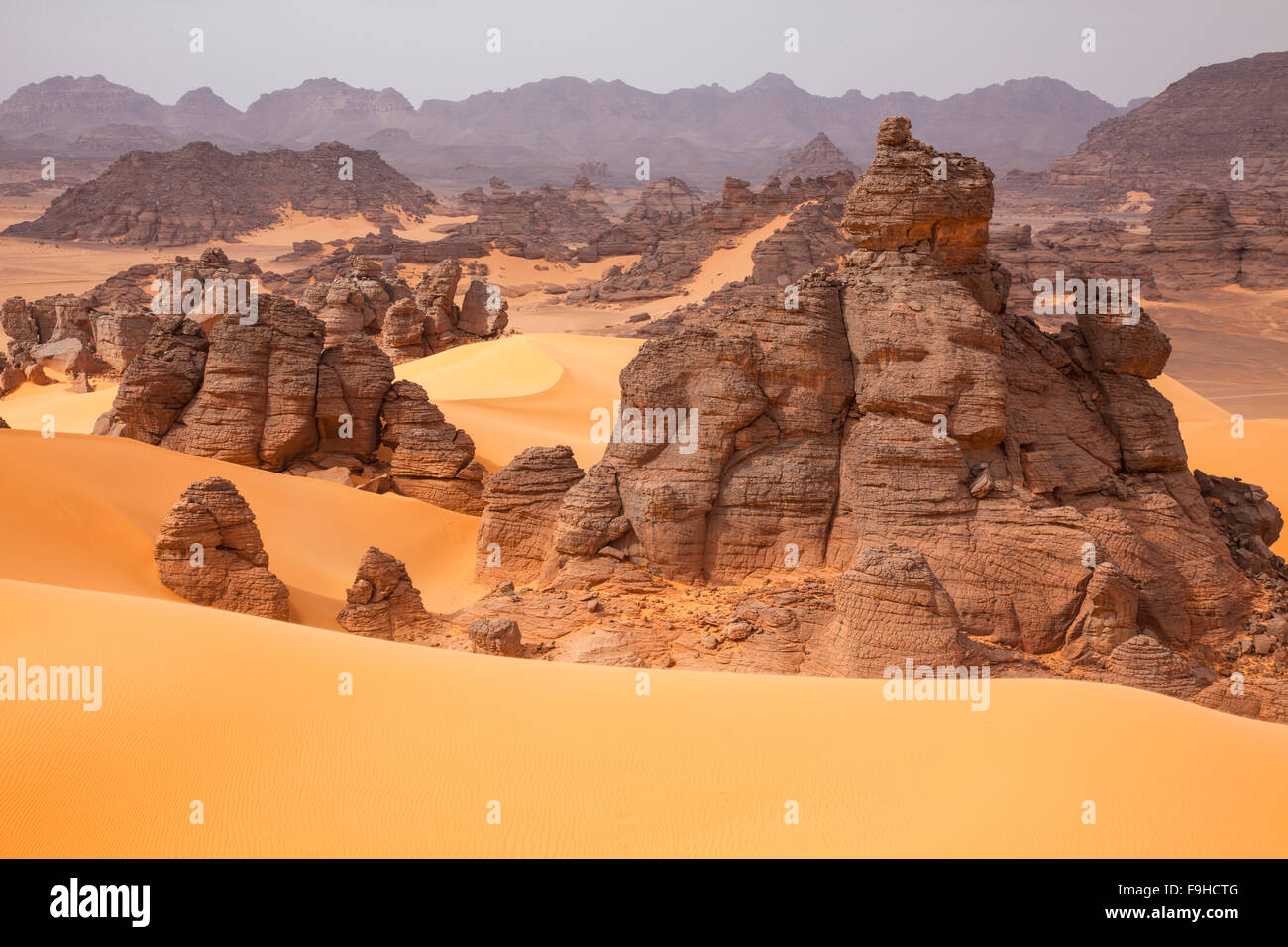 Sandstone and dunes, Jebel Acacus, LIbya, Mountains in Sahara Desert UNESCO World Heritage Site, The Awiss Stock Photo