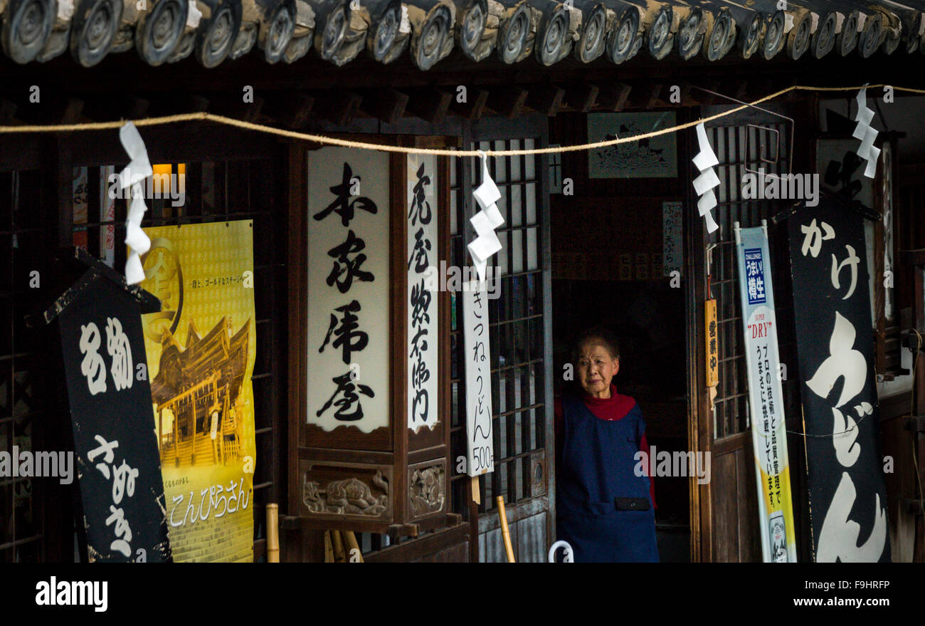 OLD LADING GAZING FROM HER STORE, KOTOHIRA  JAPAN Stock Photo