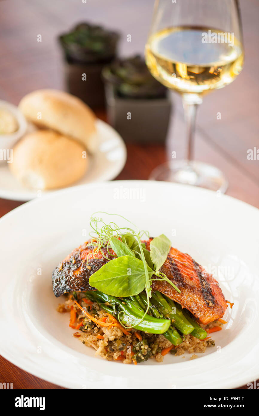 grilled Alaskan salmon with sweet and spicy broccolini, tomato miso quinoa and daikon-carrot kimchi, Ocean Grill, Avila Beach Stock Photo