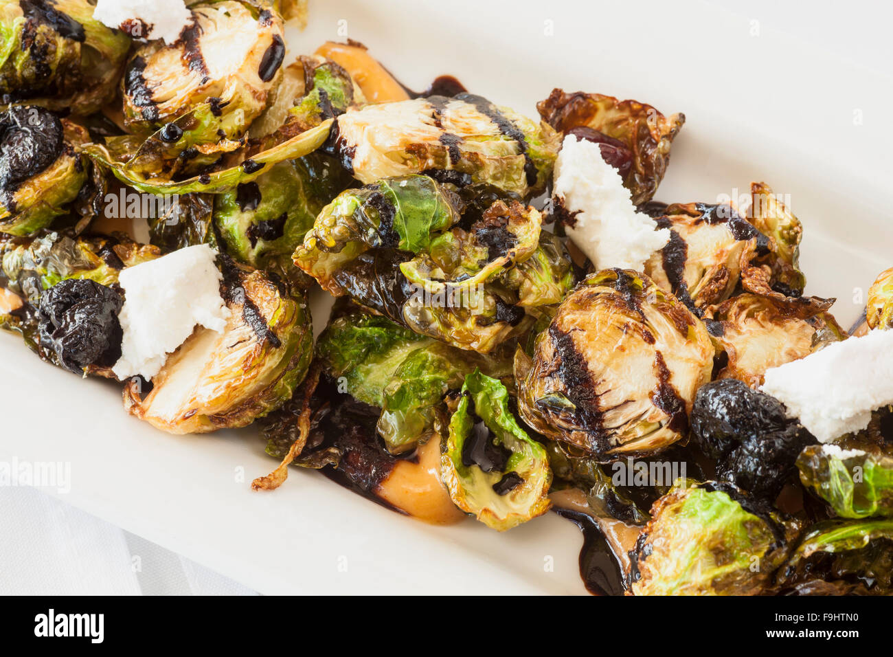 crispy brussels sprouts with smoked paprika aioli, dried cherries, goat cheese and balsamic