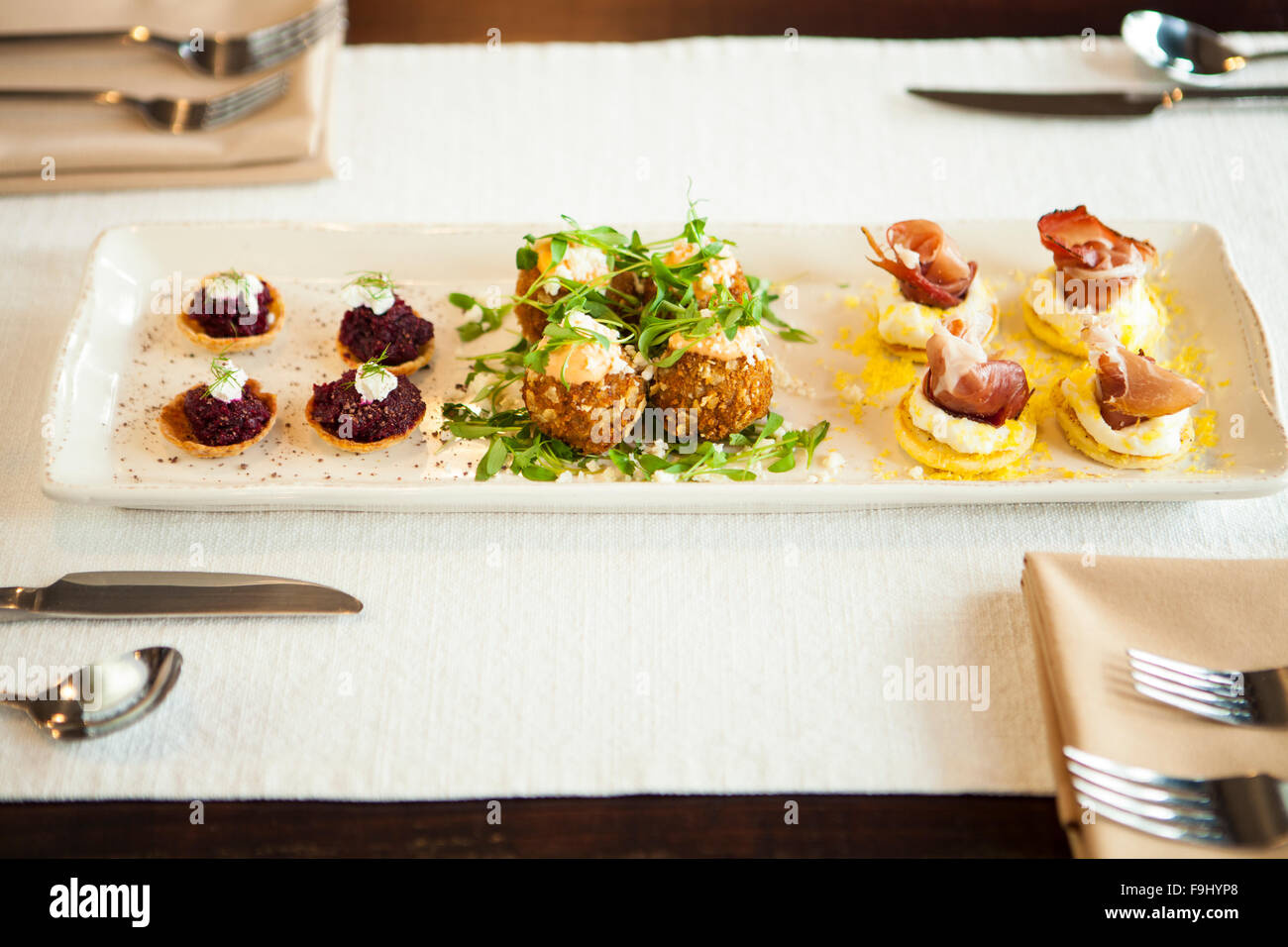 https://c8.alamy.com/comp/F9HYP8/chefs-plate-appetizer-sampler-of-eggamuffin-beet-tarts-in-parmesan-F9HYP8.jpg