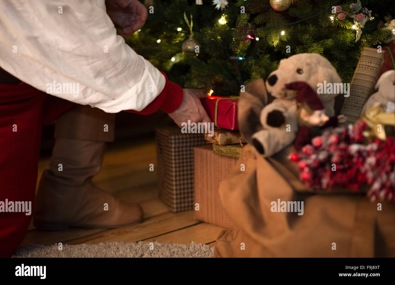Putting gifts under fir tree hi-res stock photography and images - Alamy