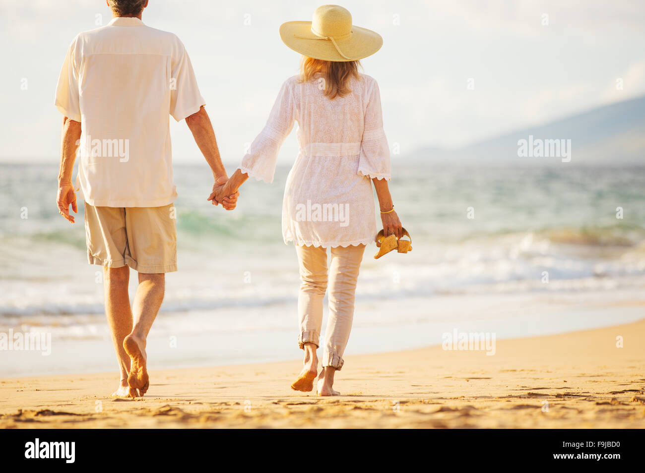 Happy Romantic Middle Aged Couple Enjoying Beautiful Sunset Walk on the ...