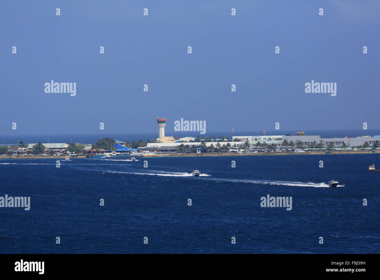 Boat traffic from the airport to the island of Male in the Maldives, Indian Ocean, as taken from a passing cruise ship. Stock Photo