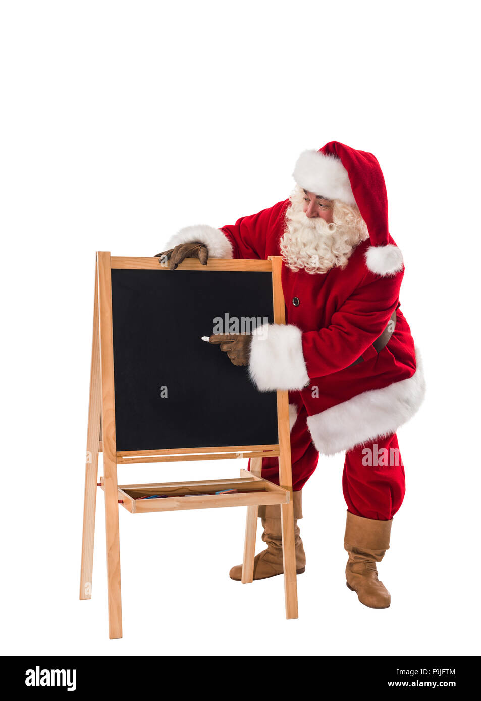 Santa Claus writing on chalkboard Full Length Portrait Isolated on White Background Stock Photo