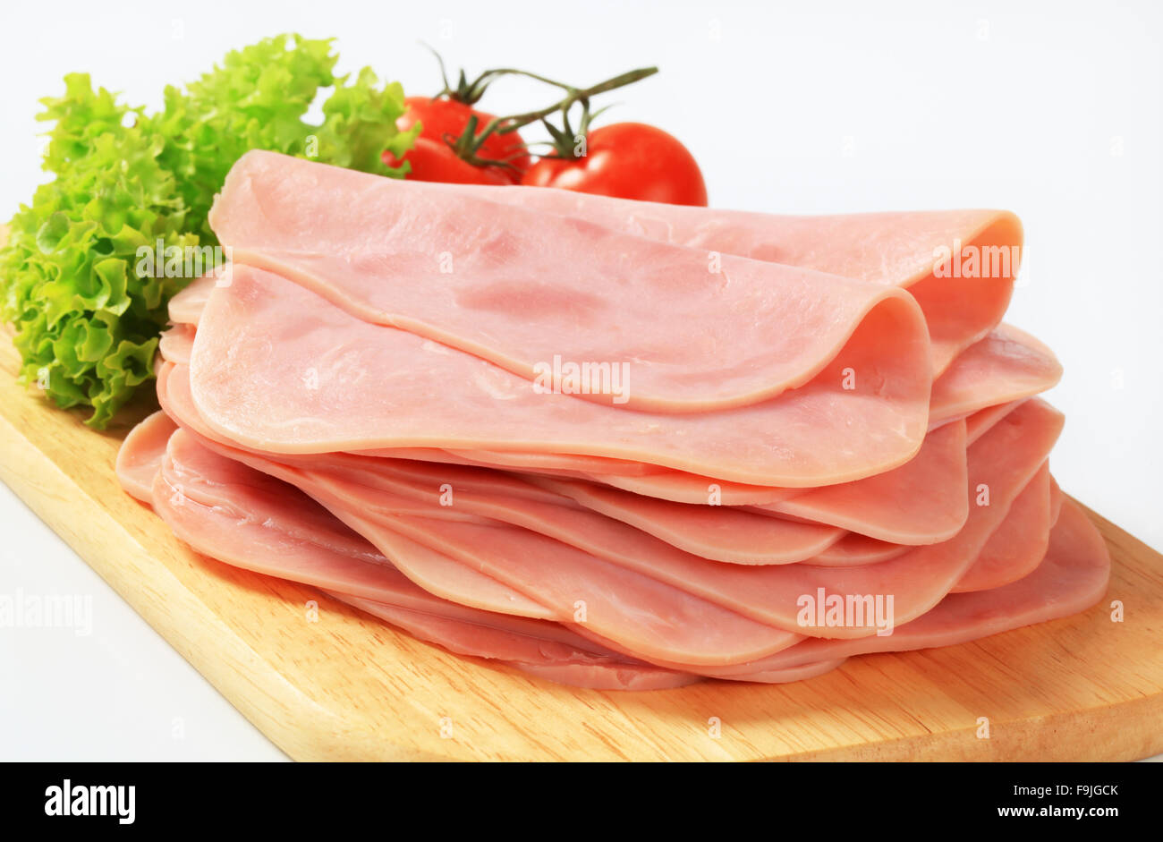 Thinly sliced ham on a cutting board Stock Photo Alamy