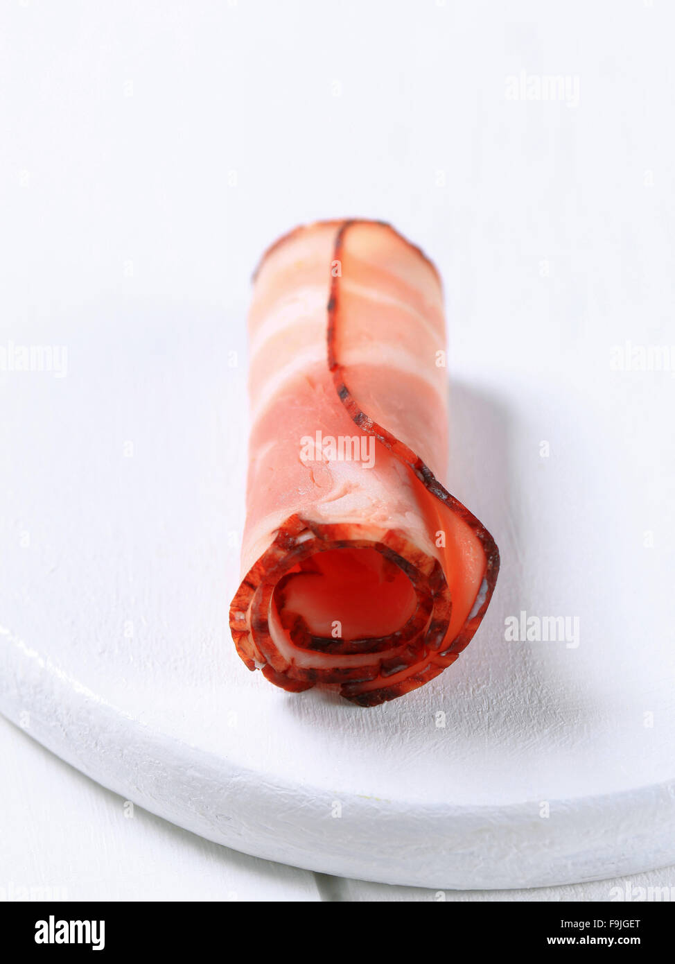 Slice of bacon, rolled up Stock Photo Alamy