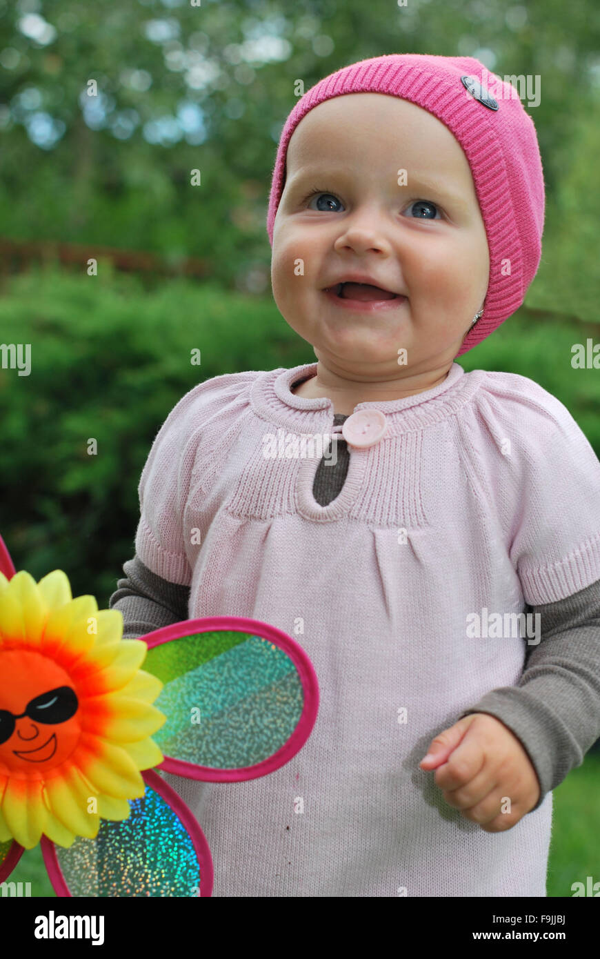 Girl with colorful pinwheel Stock Photo - Alamy