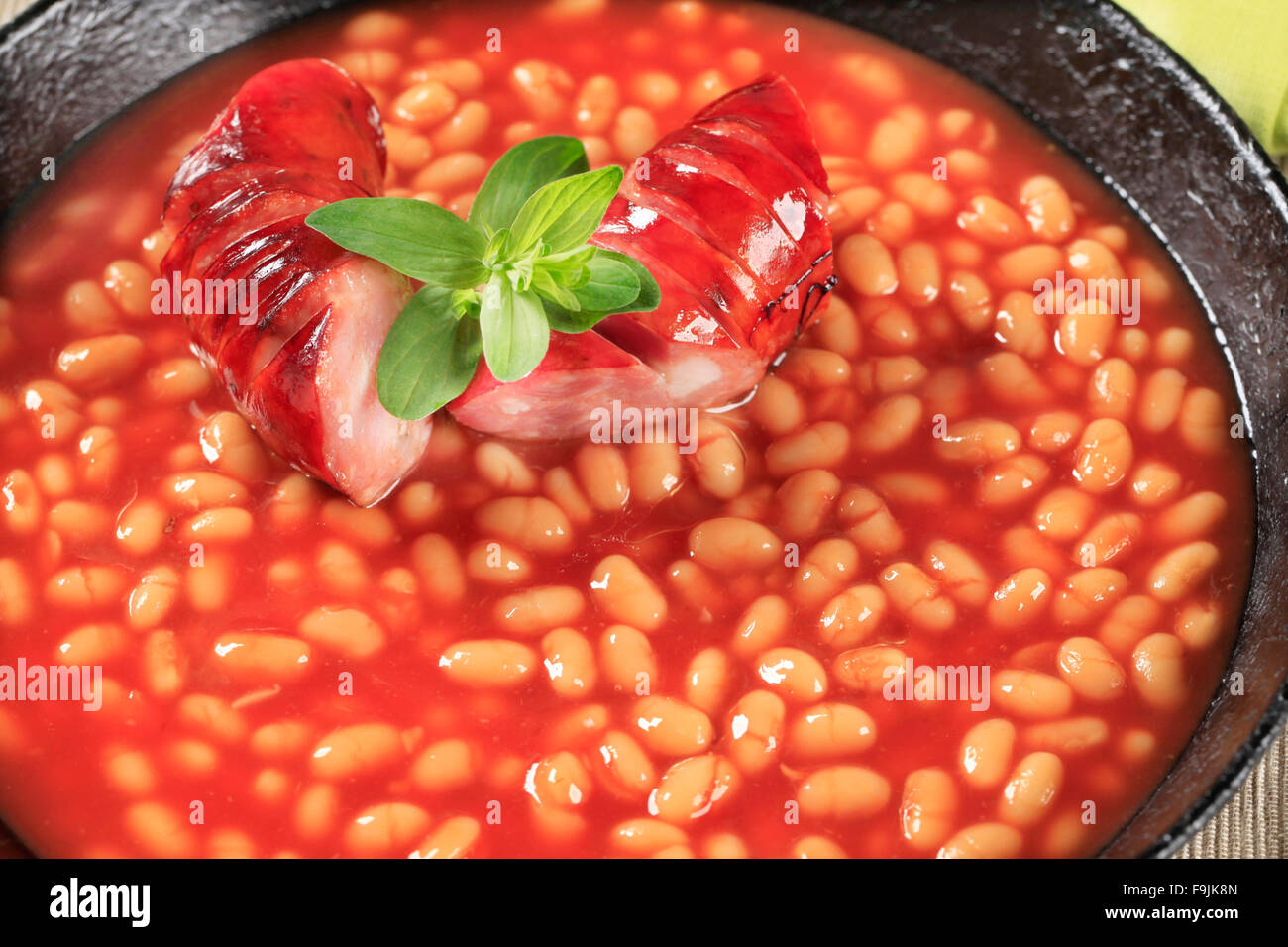 Baked beans with spicy sausage in a frying pan Stock Photo Alamy