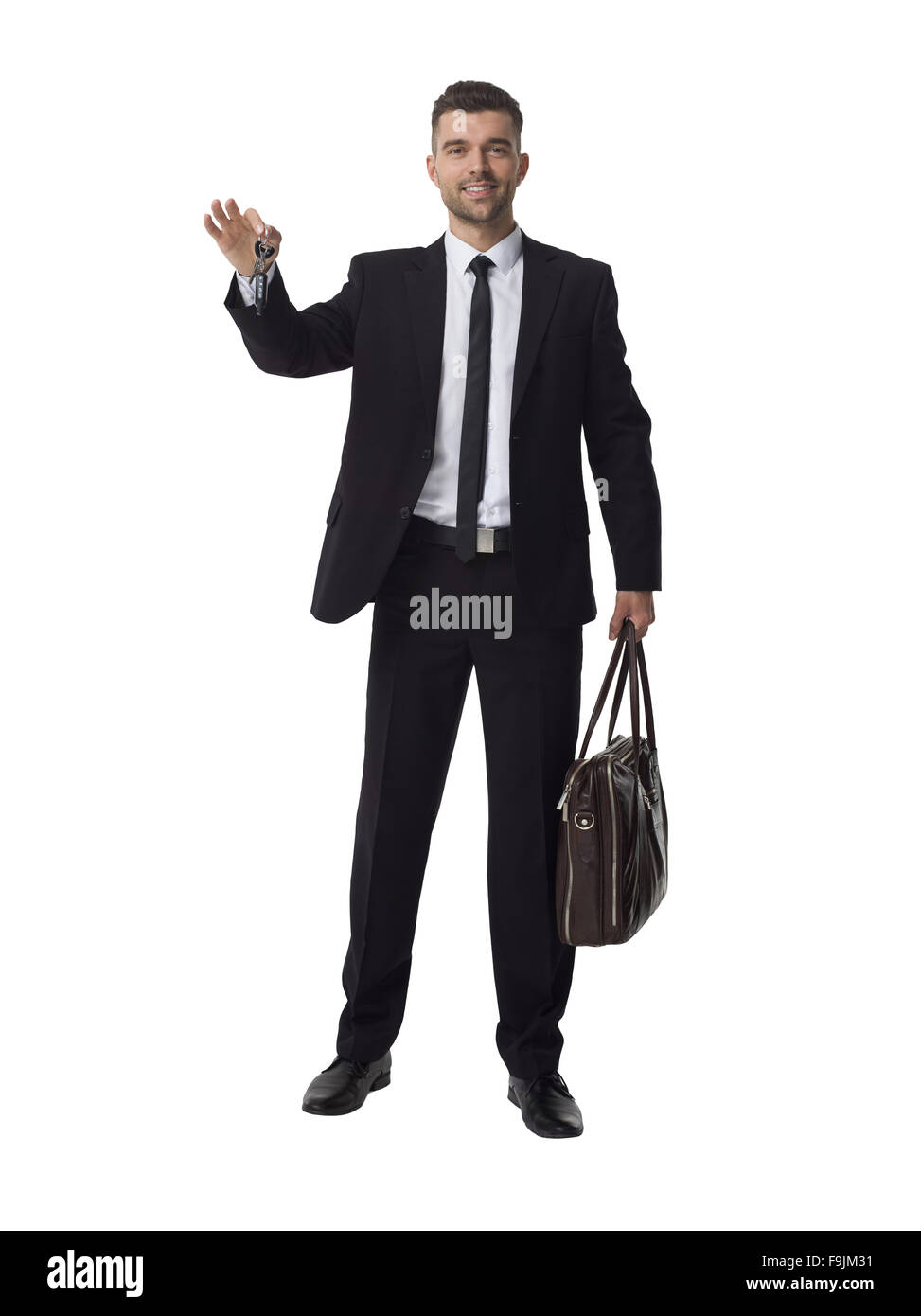 Businessman holding keys and bag Full Length Portrait Isolated on White Background Stock Photo