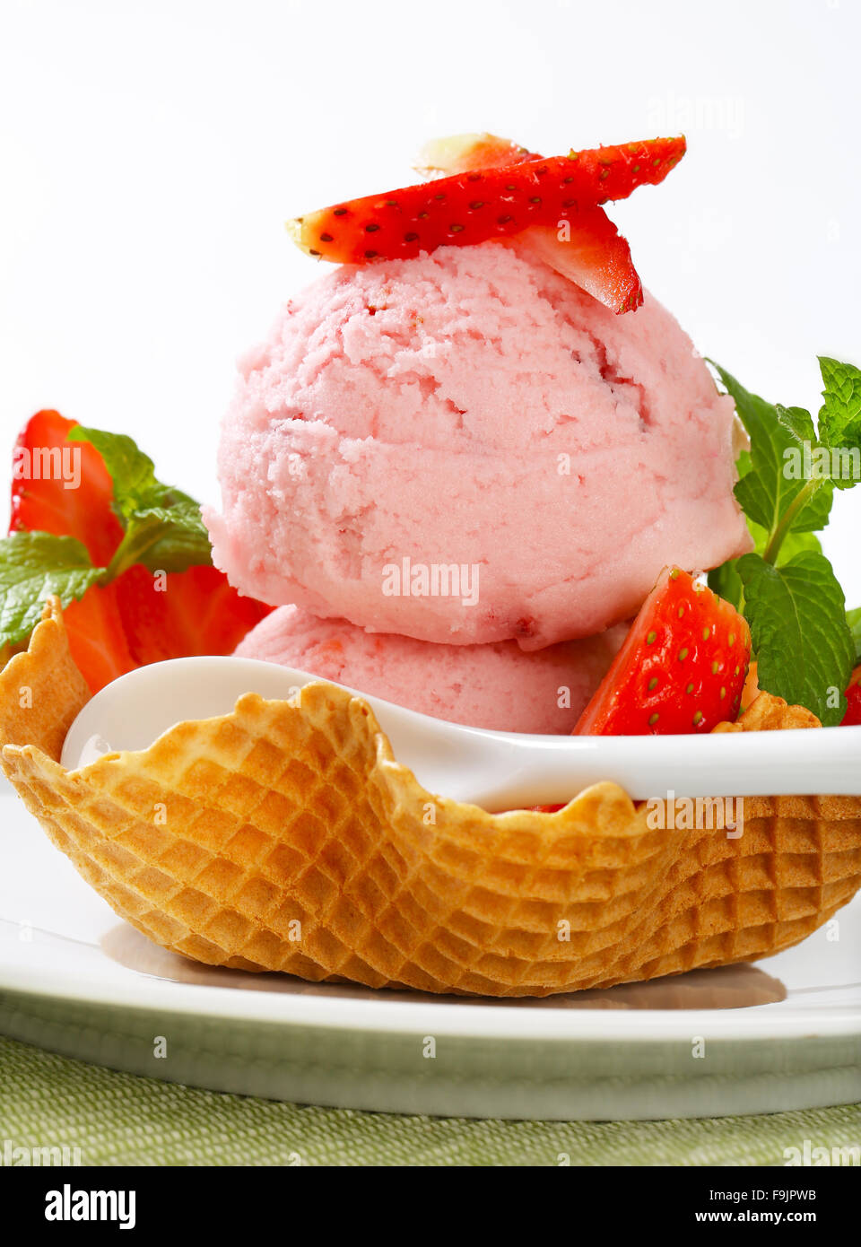 Scoops of strawberry ice cream in waffle basket Stock Photo Alamy
