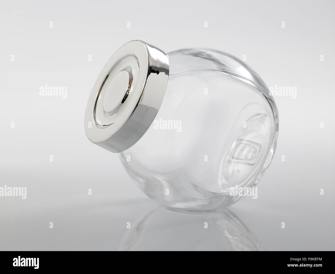 Glass jar for condiment with lid on white background Stock Photo