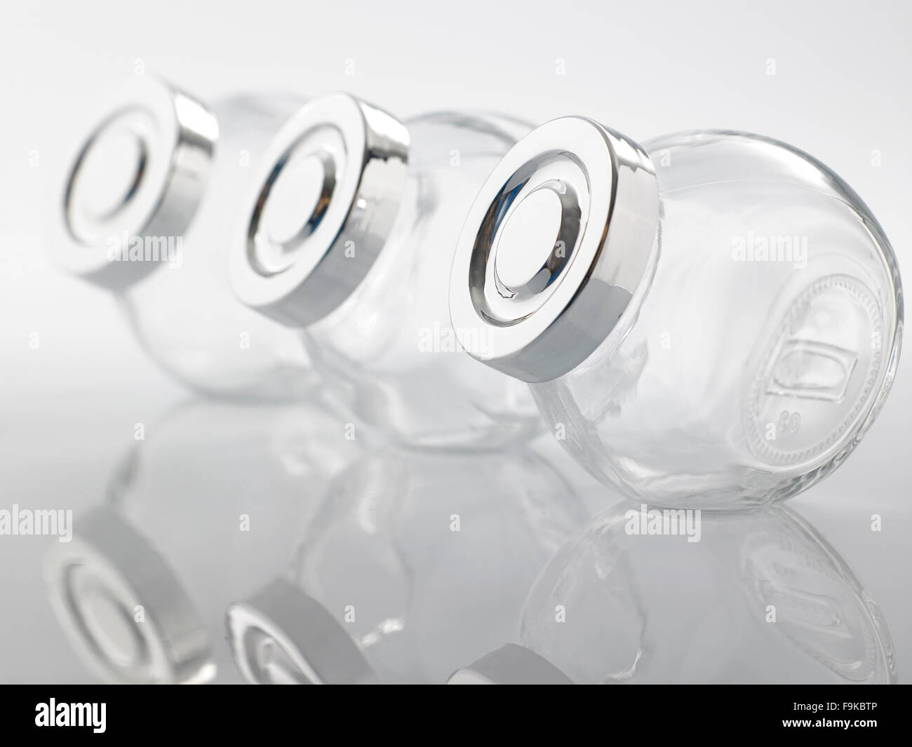 Glass jar for condiment with lid on white background Stock Photo