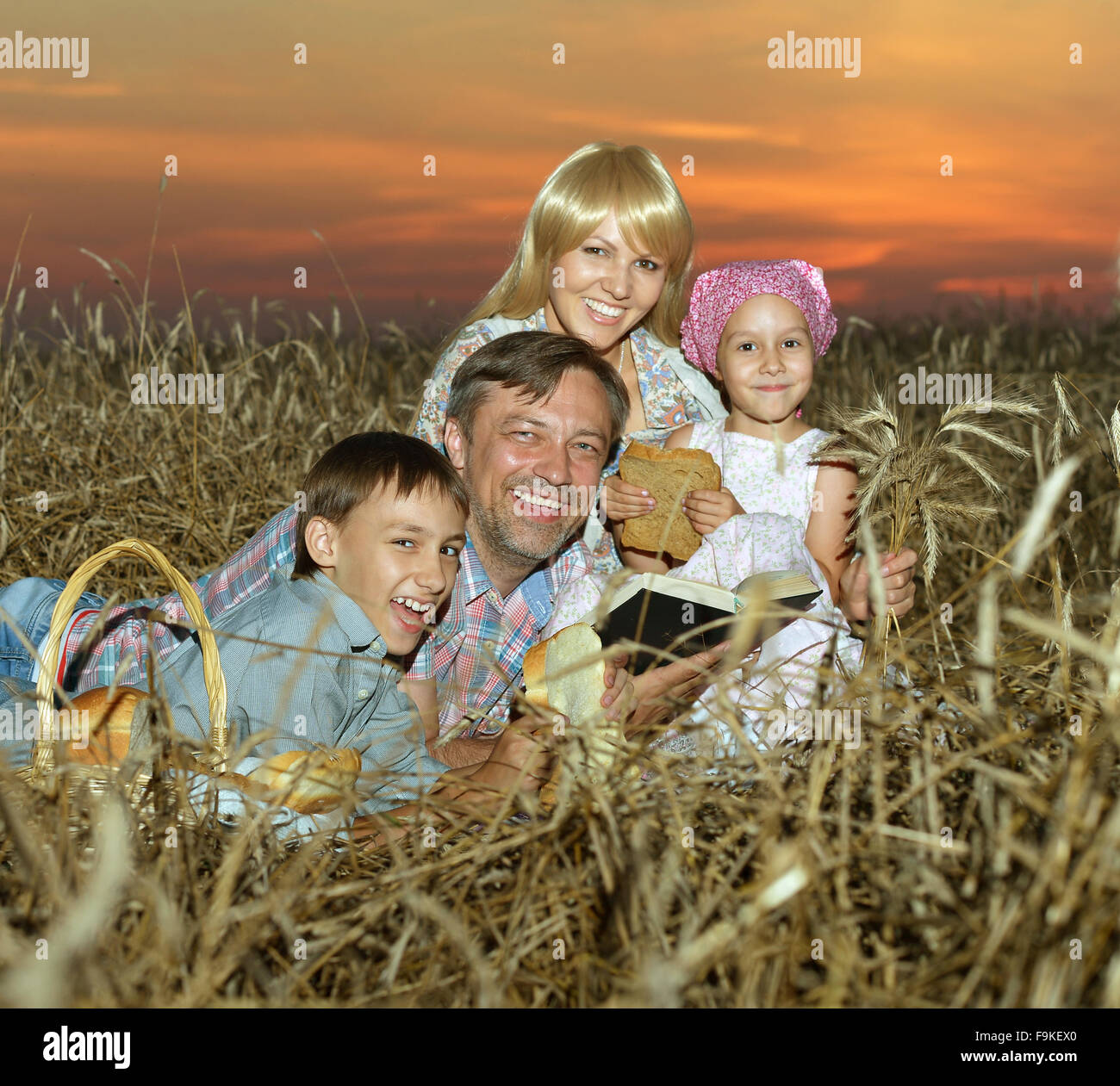 Happy family in wheat field Stock Photo - Alamy
