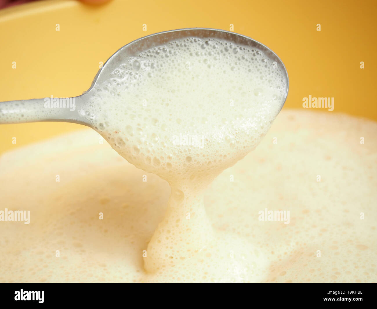 Yeast batter ready to fry. Making yeast pancakes (crepes Stock Photo