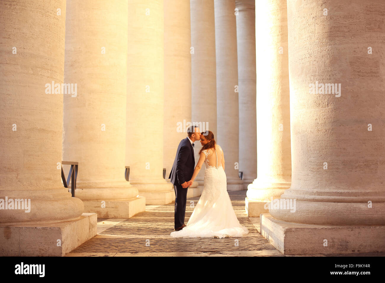 Beautiful bridal couple embracing near columns Stock Photo - Alamy