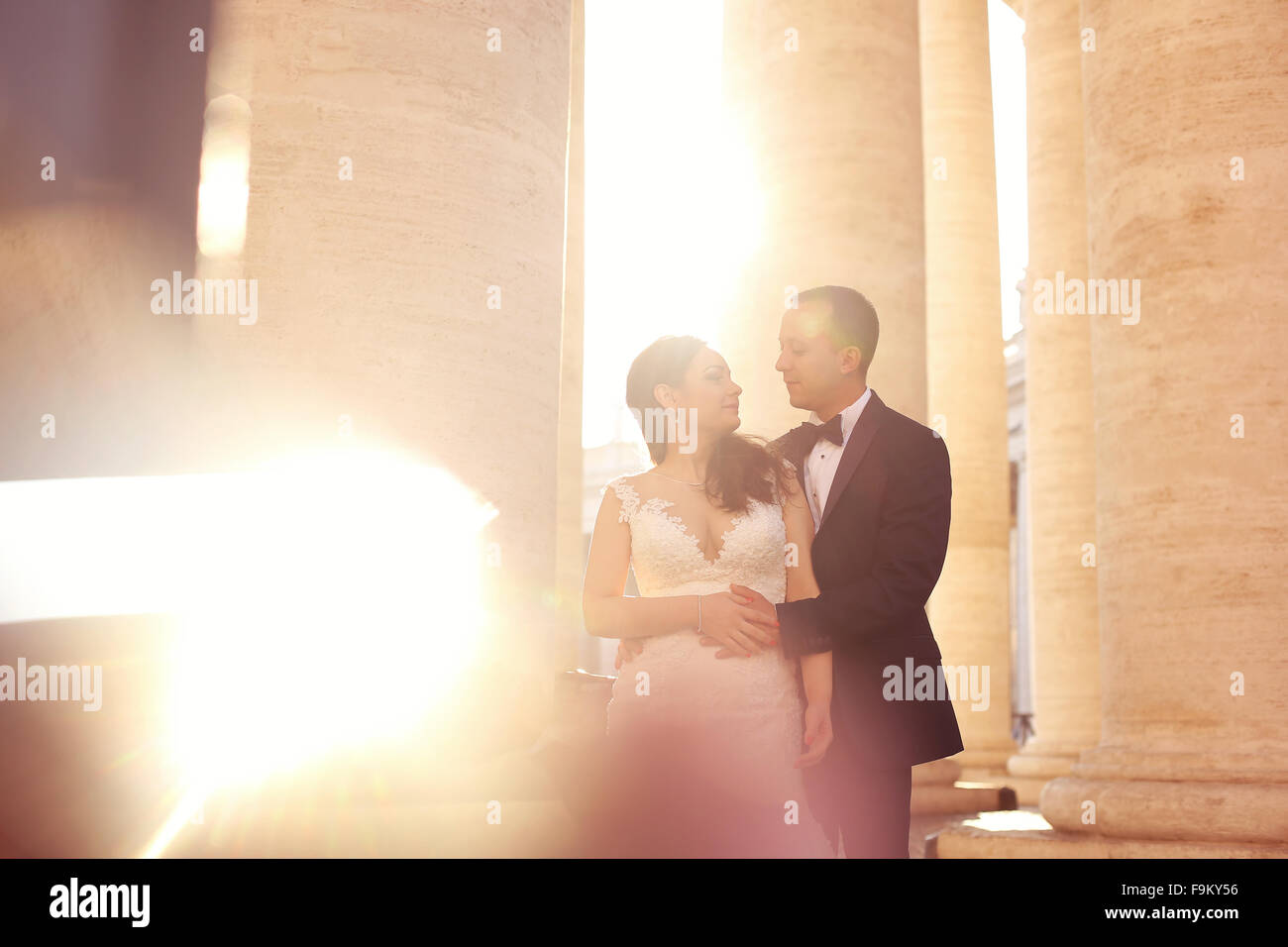 Beautiful bridal couple embracing near columns Stock Photo - Alamy