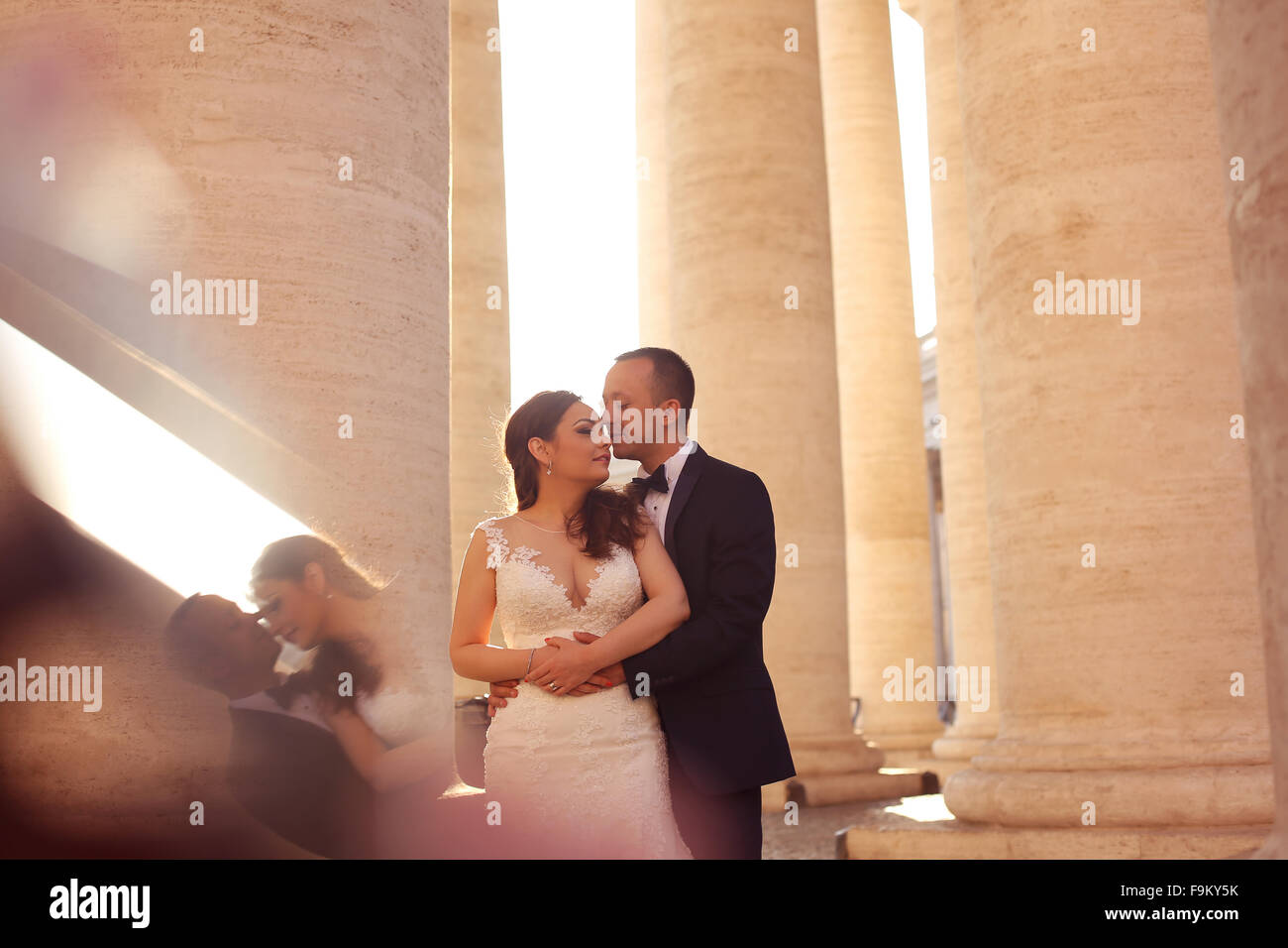 Beautiful bridal couple embracing near columns Stock Photo - Alamy
