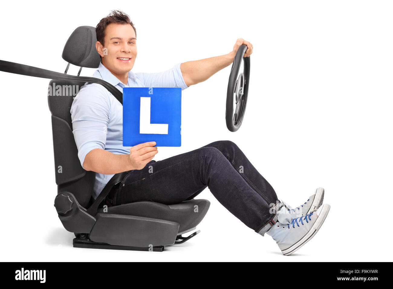 Young man holding a steering wheel and an L-sign seated on a car seat isolated on white background Stock Photo