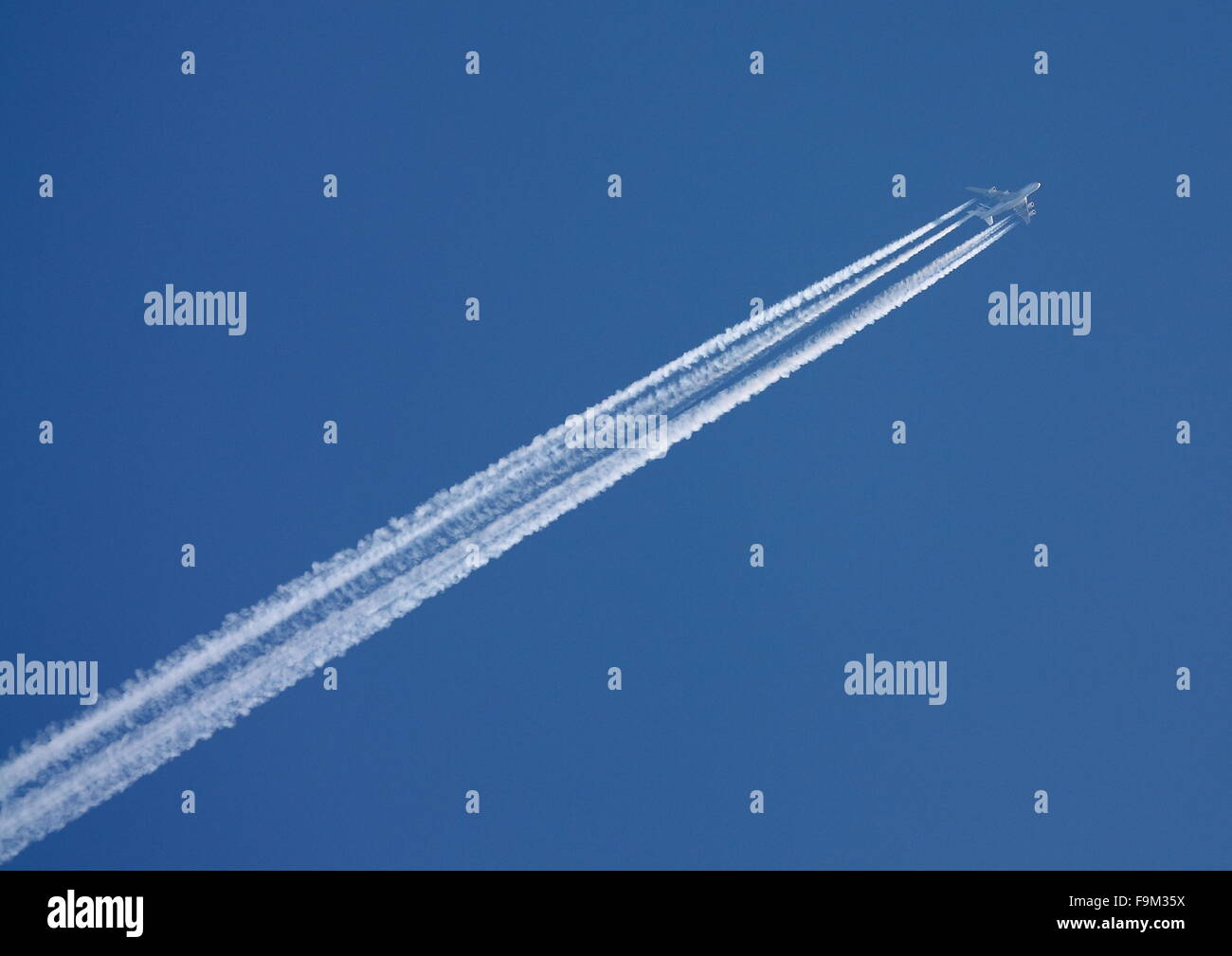 Passenger jet high in the sky Stock Photo