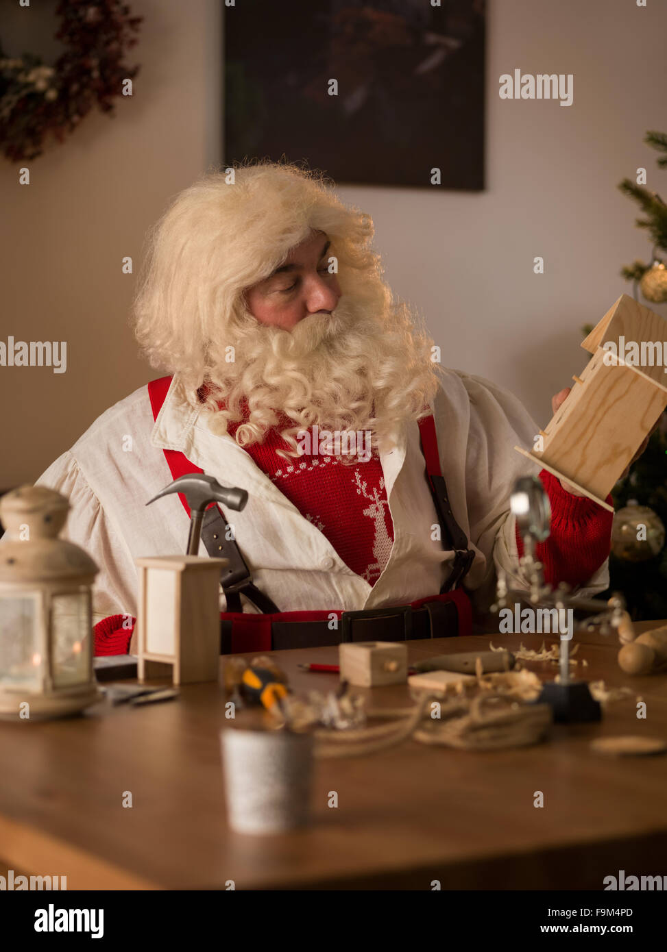 Santa claus working at home making toys for children stock photo alamy